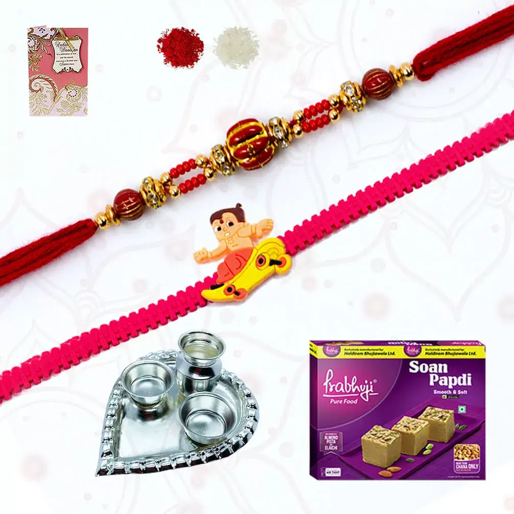 One Rudraksh rakhi with 1 chota bheem rakhi and a box of Soan Papdi and Heart shape silver plated special puja thali